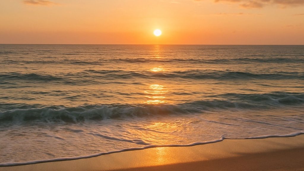 Early morning sunrise over ocean from beach