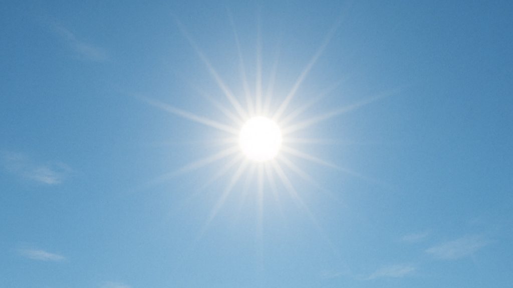 Midday sun in clear blue sky