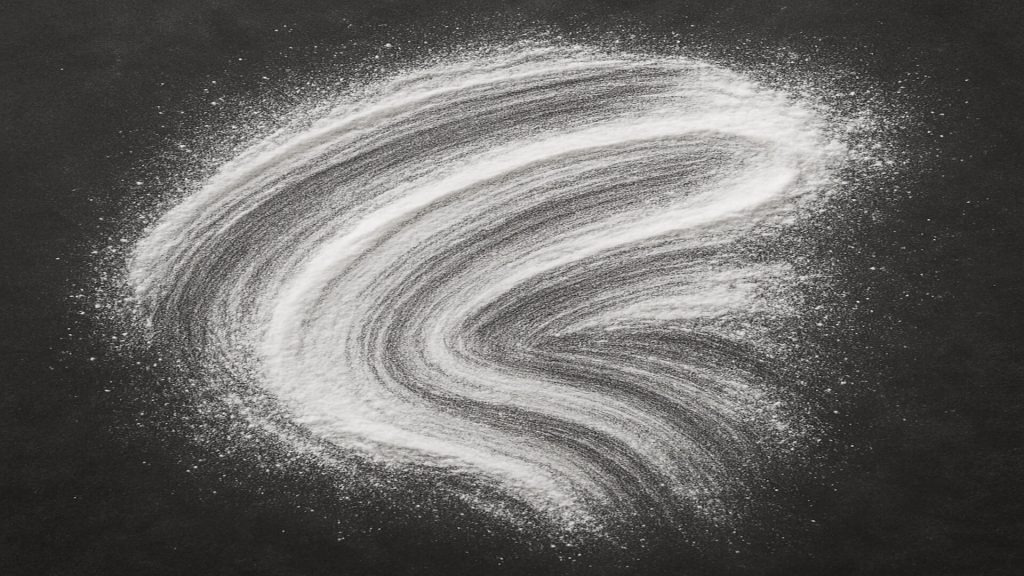 Raw azelaic acid powder brushed on dark plate